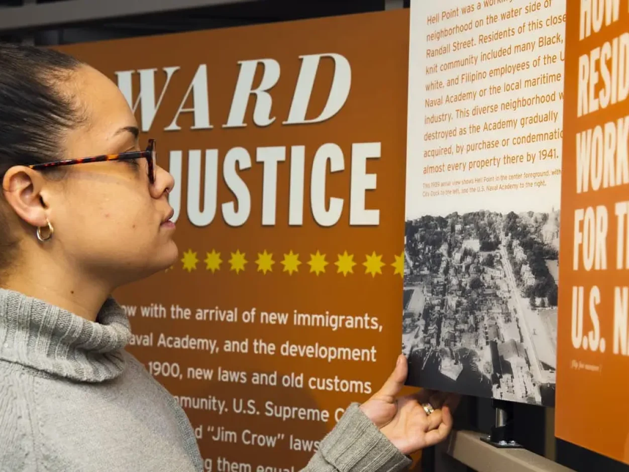 woman looking at museum exhibit about the navy